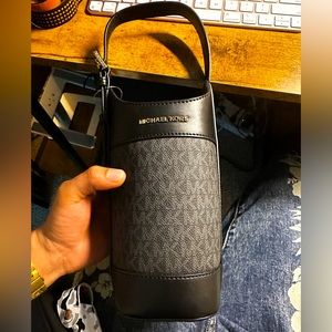 Michael Kohrs Wine Bottle Holder. Brand new and one comes in Brown and Blue.